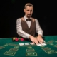 White male dealer at casino table with waistcoat and bowtie