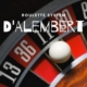 DÁlembert system text with roulette wheel and ball in background.