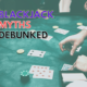 Blackjack myths debunked text with blackjack table background