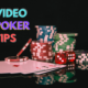 Video poker tips text with stacked casino chips and 4 ace cards